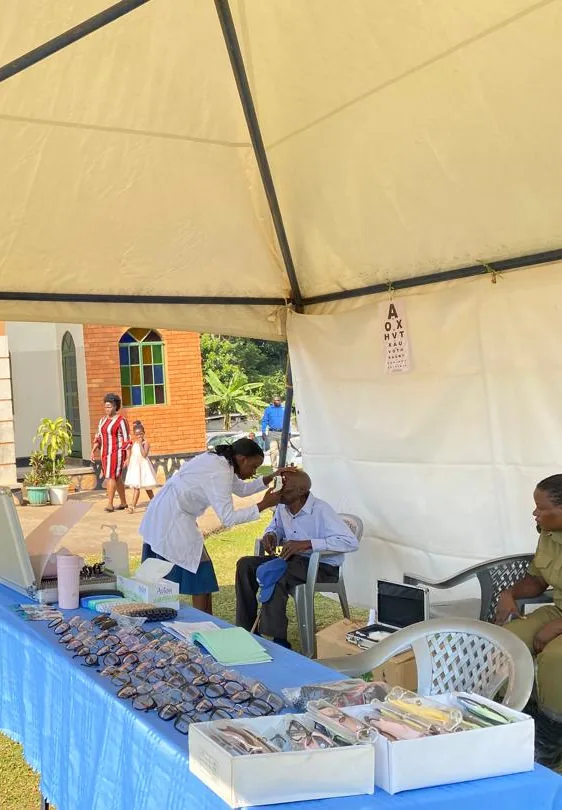 Optometrist examining a patient at a Dea Optical Centre community outreach
